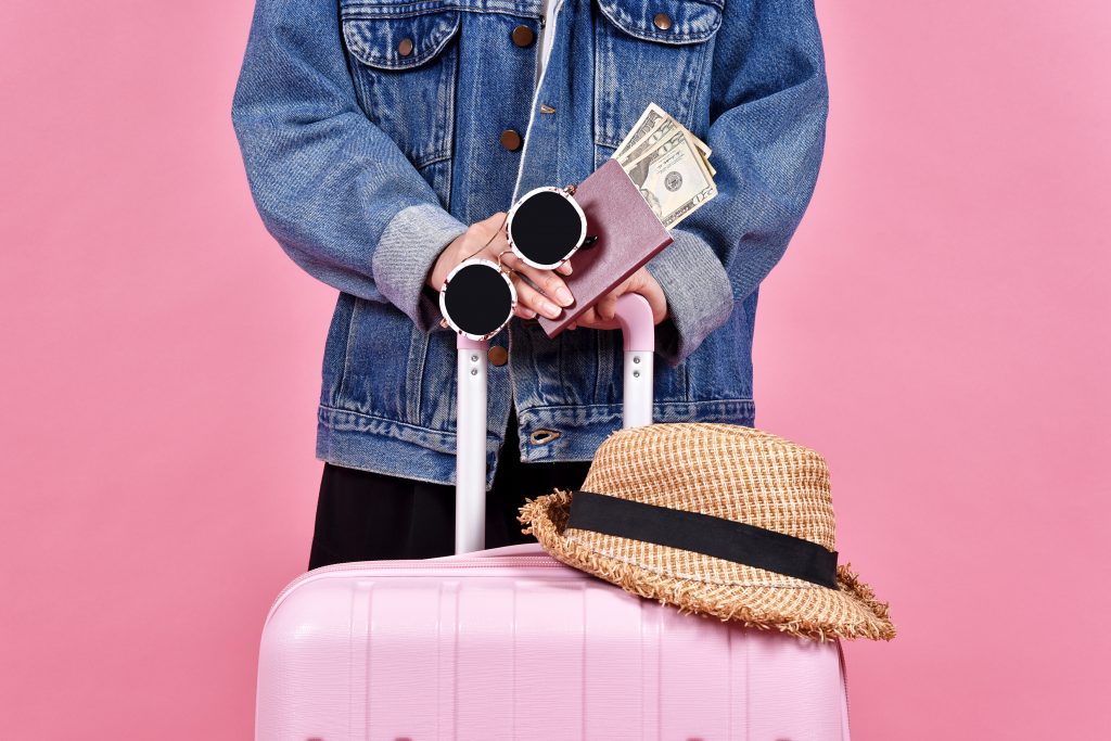 Traveler holding pink suitcase, Passenger and passport document